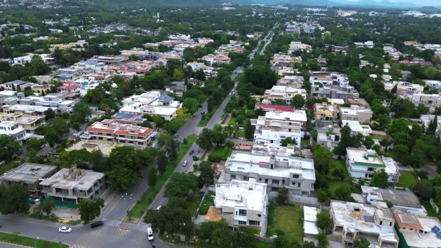 Buzzing Streets: Aerial 4K Video Showcasing Traffic at Islamabad City Center Crossroad, Beautiful panoramic aerial video from flying drone to Islamabad city center