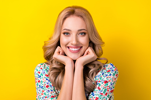 Portrait of cheerful sweet perfect lady curly hairdo two arm under chin waiting sale rejoice shopping isolated on yellow color background.