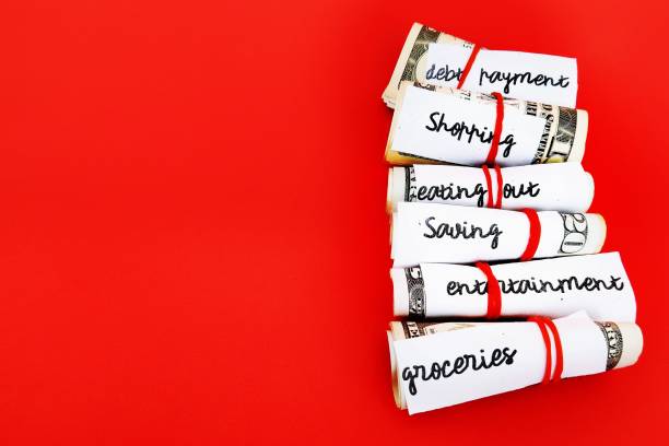 istock Money management saving budget plan -envelope method, small cash wrapped separately with rubber band limit for variety purposes spending- all on red copy space background 1522030412