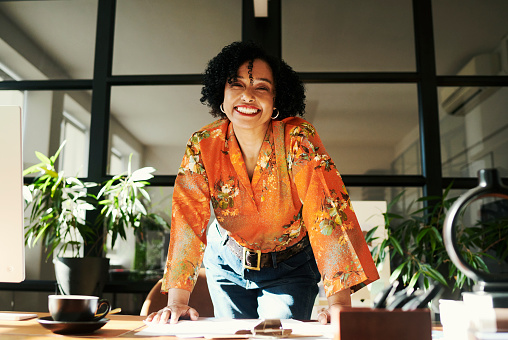 beautiful creative business woman standing happily in her office Stock photo, copy space