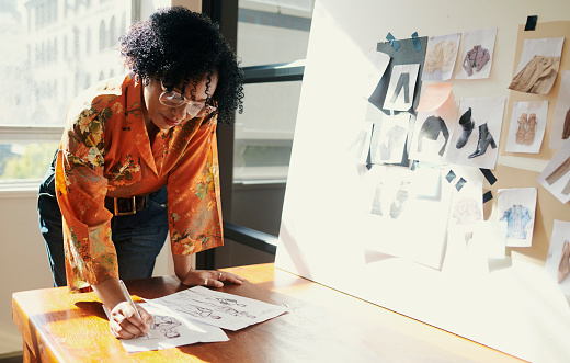 mature black female designer sketching in her studio Stock photo, copy space