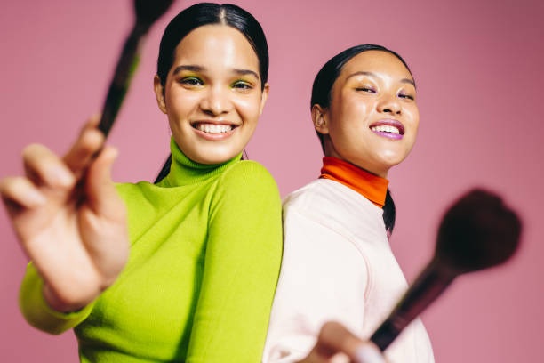 istock Fun makeup routine, two young women smile at the camera holding their beauty brushes 1522077994