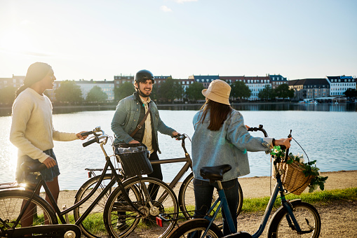 Young adult friends out sightseeing around Copenhagen by bike.