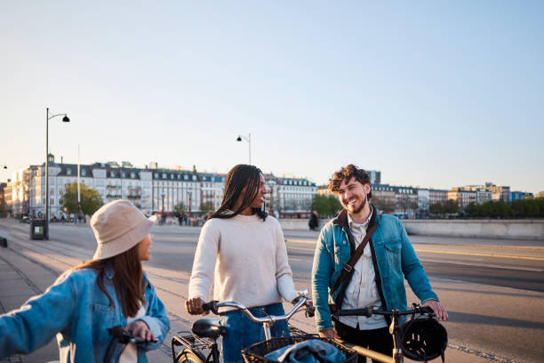 Cityscape Connection: Multi-Ethnic Friends Create Memorable Moments through Cycling stock photo