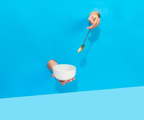 istock a hand is holding a spoon and a bowl 1522149345