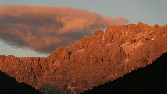 Sunset in the Sella range in the Dolomites, Italian Alps, illuminating the rocks in red color