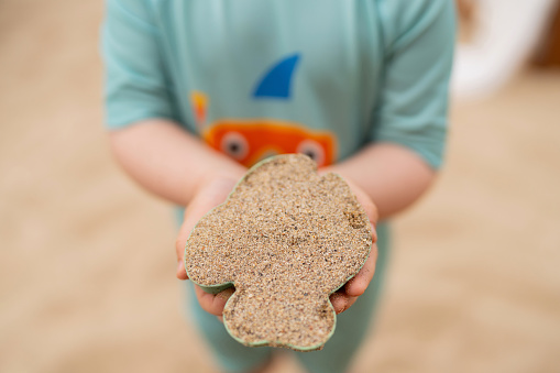 Sand mold in a child's hands.