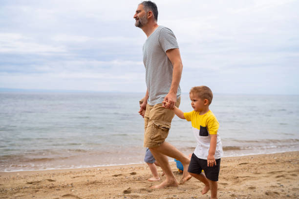 istock Father with two sons on the beach 1522170536