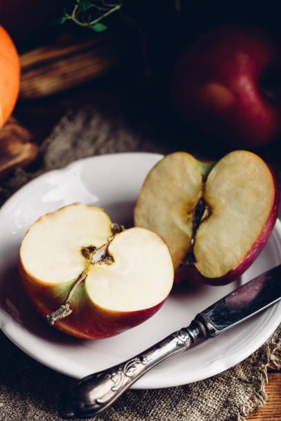 istock Two Halves of Red Apple on White Plate 1522170537