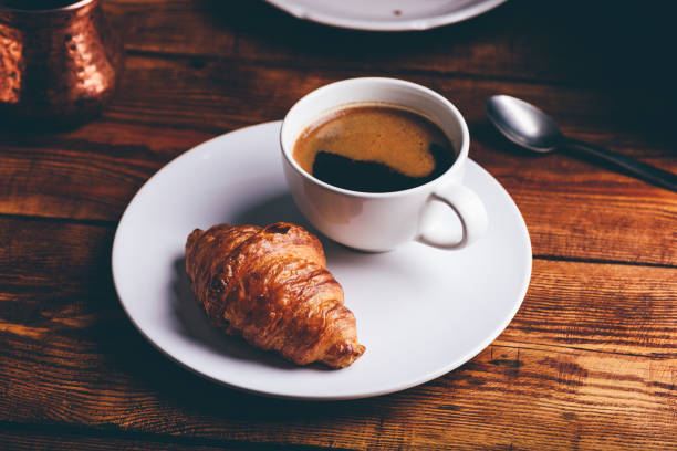 istock Cup of Black Coffee and Fresh Croissant 1522170542
