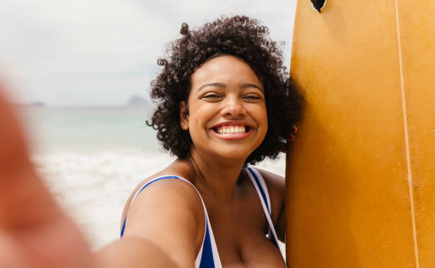 istock Happy taking a selfie with her surfboard, celebrating summer at the beach 1522176341