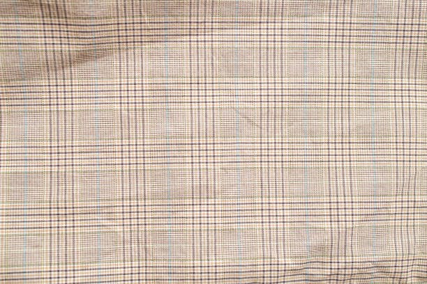 istock Checkered pattern on beige fabric, close up of textile texture 1522181190