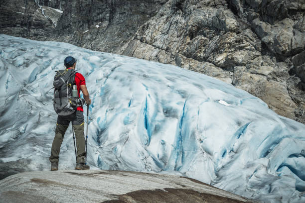 Hiker Staying in Front of Scenic Norwegian Glacier Head