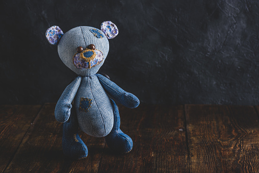 Handmade Stuffed Bear Toy Standing on Wooden Table