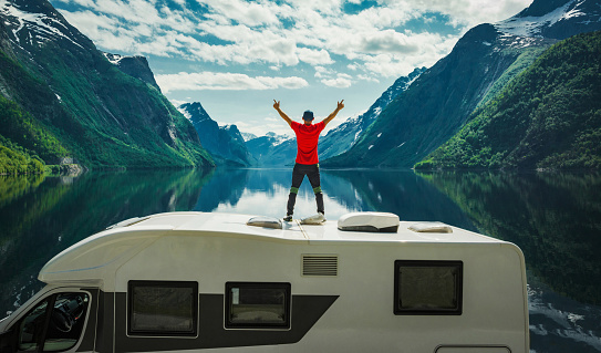 Man Expressing His Happiness While Staying on His Camper Van Seeing Perfect Norwegian Landscape