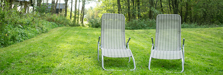 Red wood chair in green garden. loneliness concept idea for single person.
