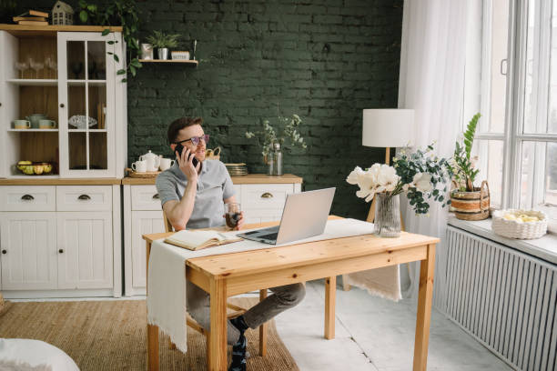 istock Trader talk on phone, investor broker analyze indexes. Serious man working, learning on laptop in home office. Freelance. Communication. Trading online investment data on stock market, cryptocurrency. 1522189835