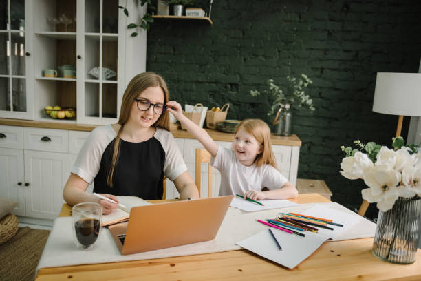 istock Woman working, learns on laptop computer. Mother working with kid at home. Child playing, make noise, distract, disturb mom. Angry and tired woman. Writing, typing. Technology concept. Maternity leave 1522189841