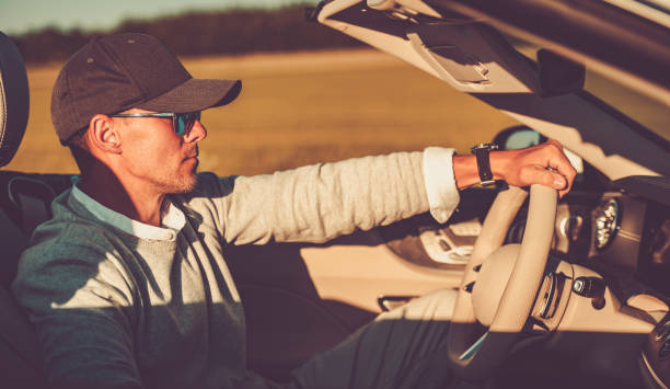 istock Wealthy Middle Aged Man Driving His Convertible Without Roof 1522198821