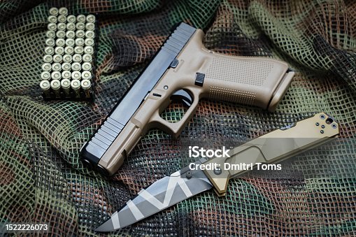 istock Handgun,tactical knife and bullets 1522226073