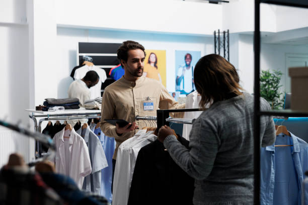 istock Worker showcasing shirt to customer 1522252943