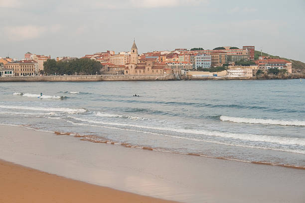 Cold day surfing in Gijón stock photo