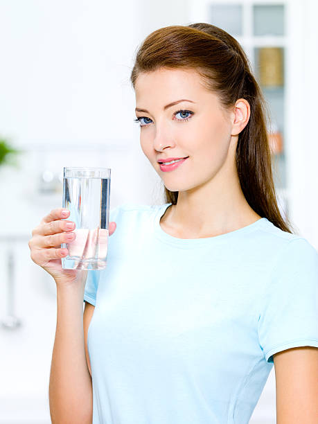 istock woman holds a glass with water 152227373