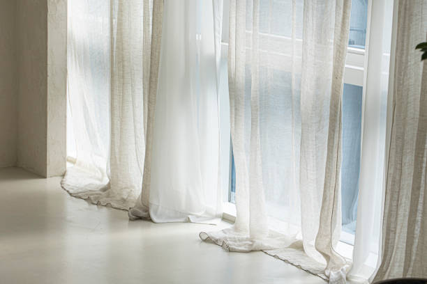 istock beige background with light and shadow of window curtains 1522282104