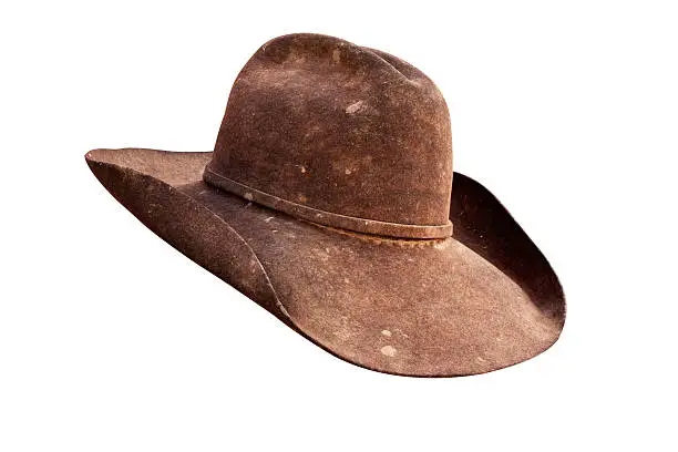 Well worn leather cowboy hat with all grunge intact. Work path.