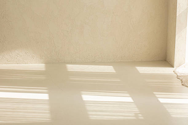 istock light beige painting background with light and shadow on wall. 1522286407