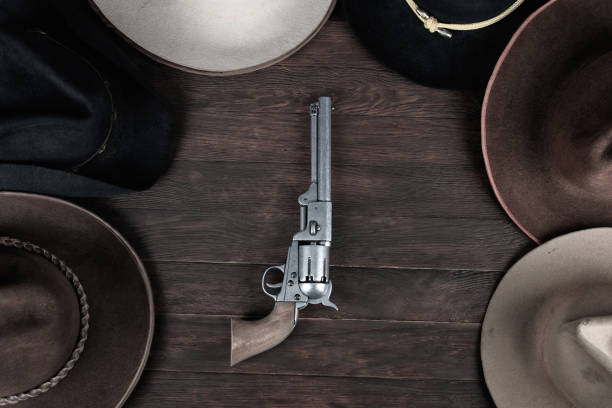 istock Gun with old west hats on table. Top view. 1522292277