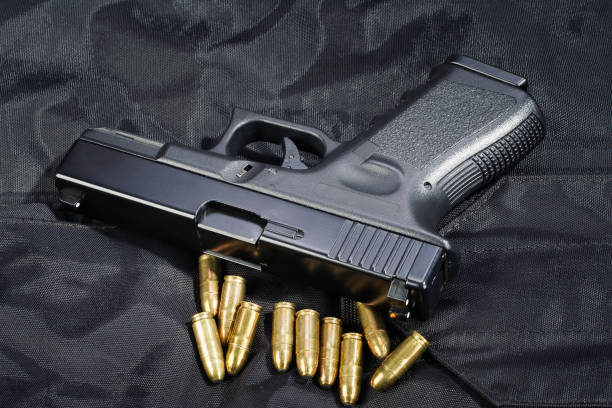 istock Police hand gun on black uniform 1522295976