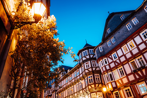 Street with beautiful half-timbered houses at dusk in Marburg, Germany