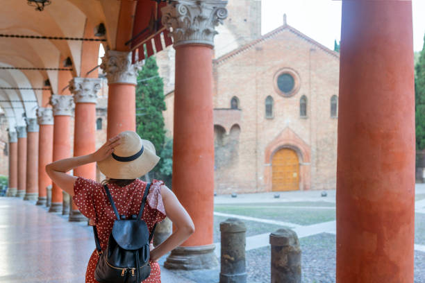 Young elegant  tourist with hat looking at Piazza santo Stefano, Bologna - Italy stock photo