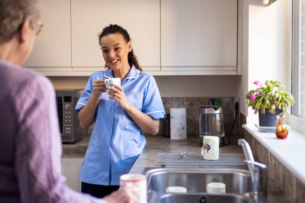 Young Female Home Nurse Talking with Patient