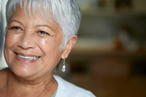 Closeup portrait of a happy senior woman looking to the side