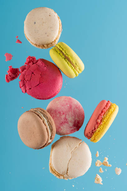 istock a bunch of scattered macarons on a blue background 1522352707