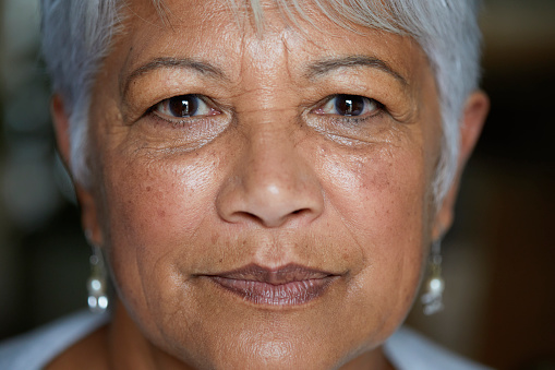 Closeup portrait of a serious senior woman looking into the camera