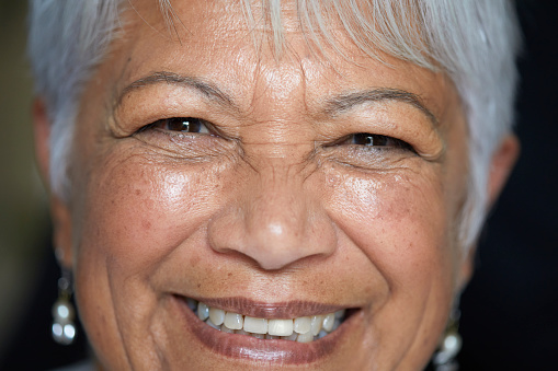 Closeup portrait of a serious senior woman looking into the camera