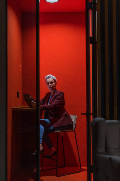 istock Serious Mature Female Customer Representative Working In A Red Cubicle 1522377391