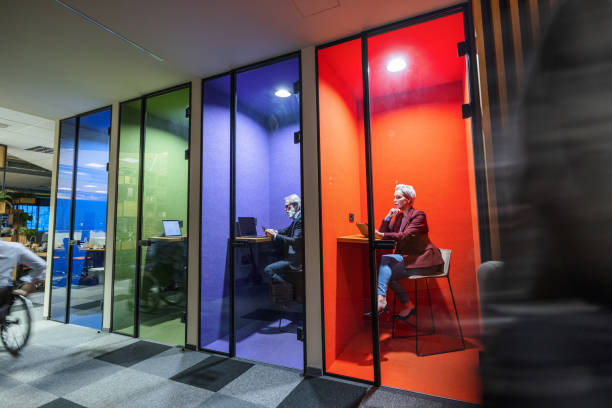istock Businesspeople Working In A Modern Office With Colorful Cubicles 1522378657