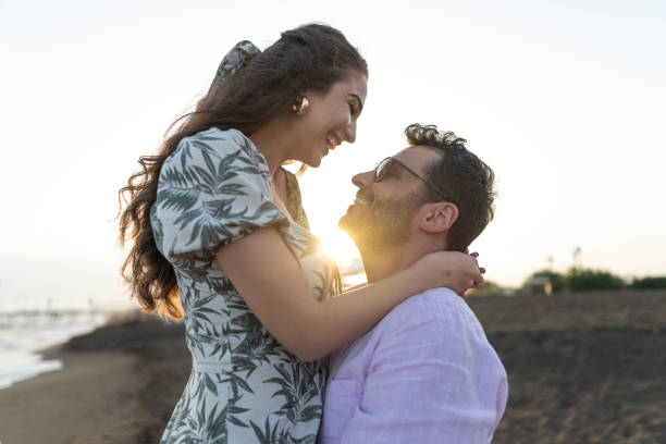 istock Romantic couple in love cuddling outdoors during sunset. 1522396004