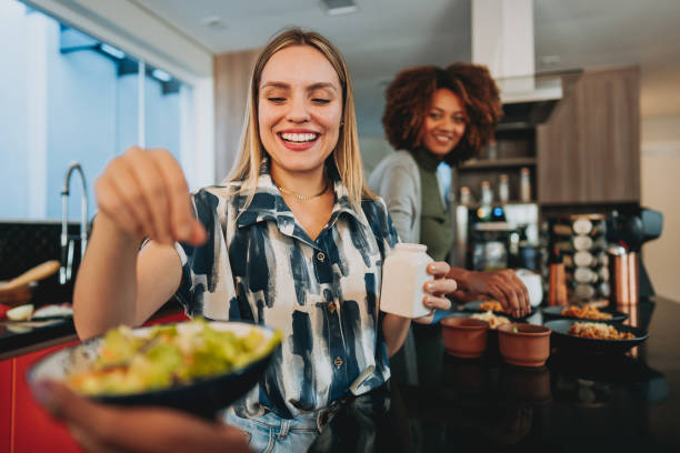 Woman seasoning the salad