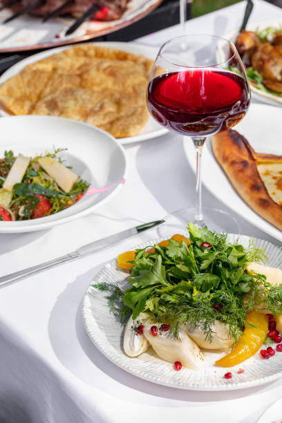 istock Pancakes with suluguni cheese and herbs with paprika and pomegranate on a light ceramic plate. The plate stands on a light tablecloth, behind you can see a plate with tabouleh and a plate with chebureks. 1522421799