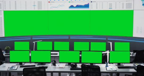istock Empty Monitoring Office With Green Screen Chromakey Desktop Computer Monitors Of Employees. Big Digital Screens Showing Graphs And Charts. Mockup Template Of Successful Financial Analytics Company. 1522425892