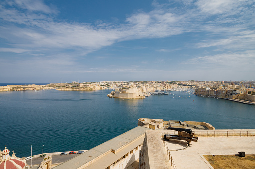 Grand Harbour of Malta with the ancient walls of Valletta on a sunny day.