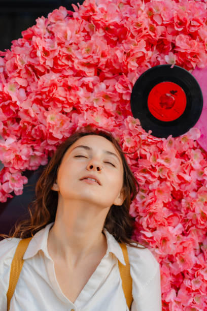 Free Stock Photo of Woman surrounded by flowers with her eyes closed ...