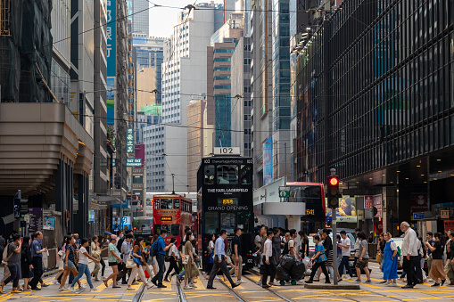 Hong Kong - July 7, 2023 : Pedestrians walk past the Des Voeux Road Central in Central, Hong Kong.