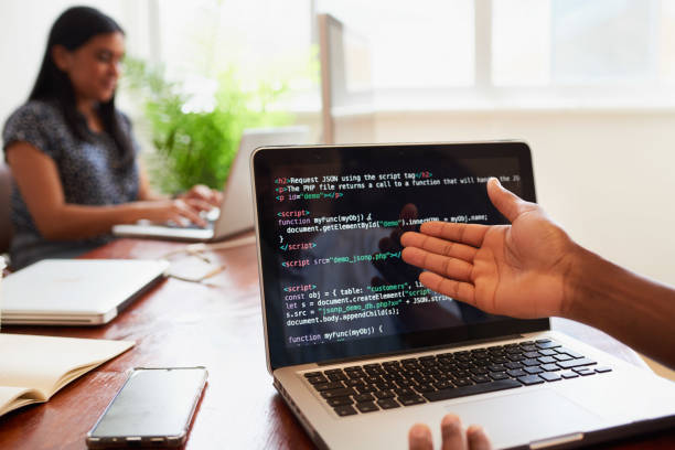 istock Over the shoulder shot of young developer gesture to code on laptop in office 1522441339