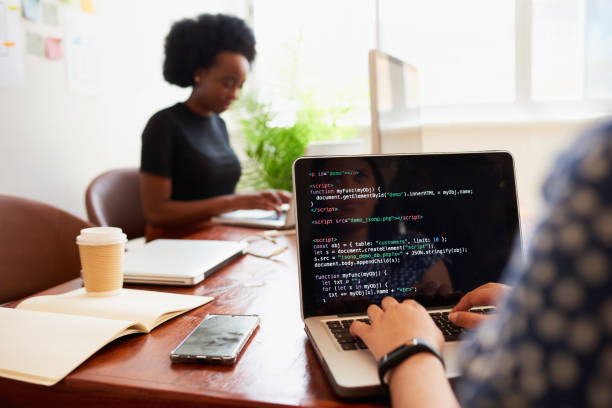 istock Over the shoulder shot of young woman developer typing code on laptop in office 1522441883